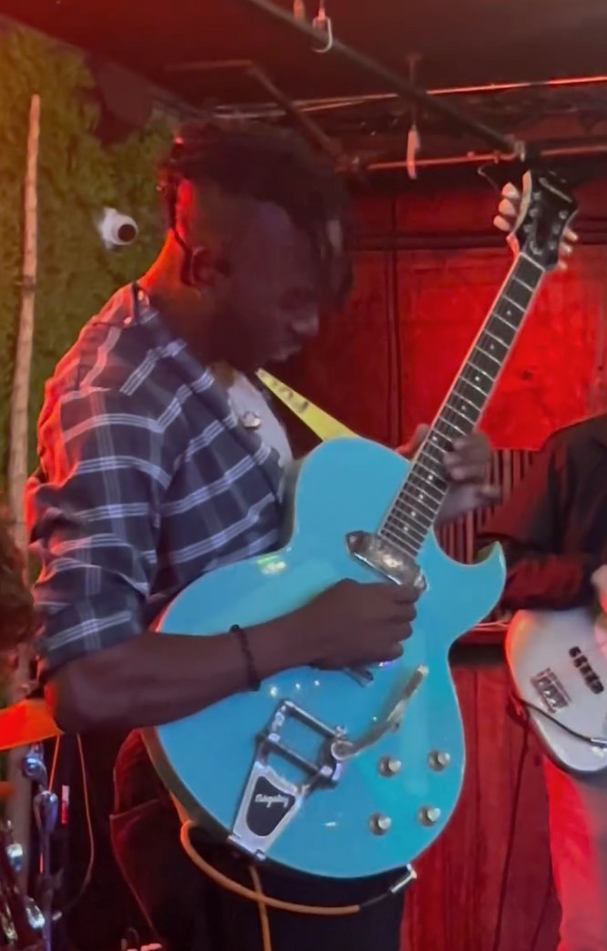 Guitarist with blue hollowbody guitar